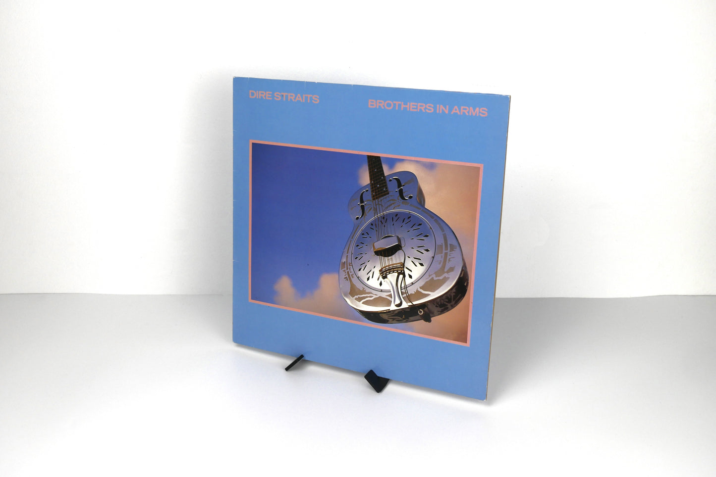 Modern vinyl stand showcasing record cover on tabletop